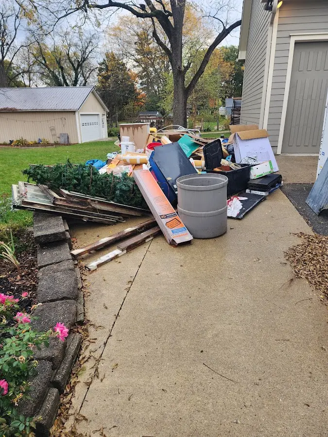 Dumpster being loaded with debris for 12 Yard Dumpster Rental in Crawfordsville